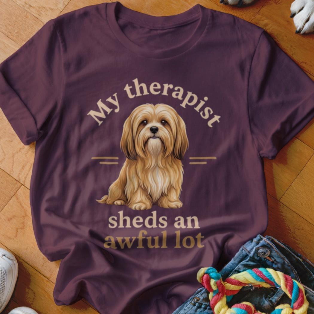 T-shirt with brown fluffy dog illustration and text "My therapist sheds an awful lot".