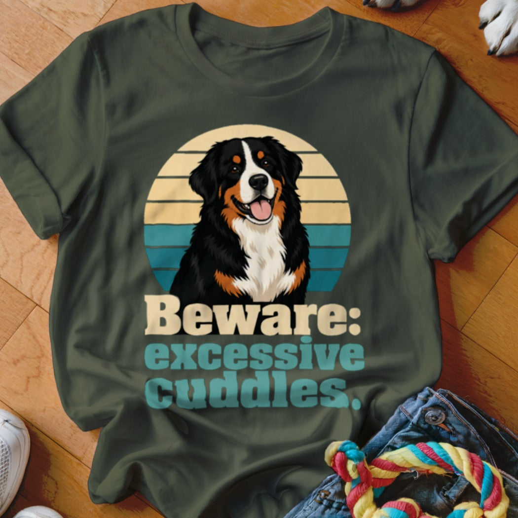 Bernese Mountain Dog with text "Beware: excessive cuddles." on green t-shirt.
