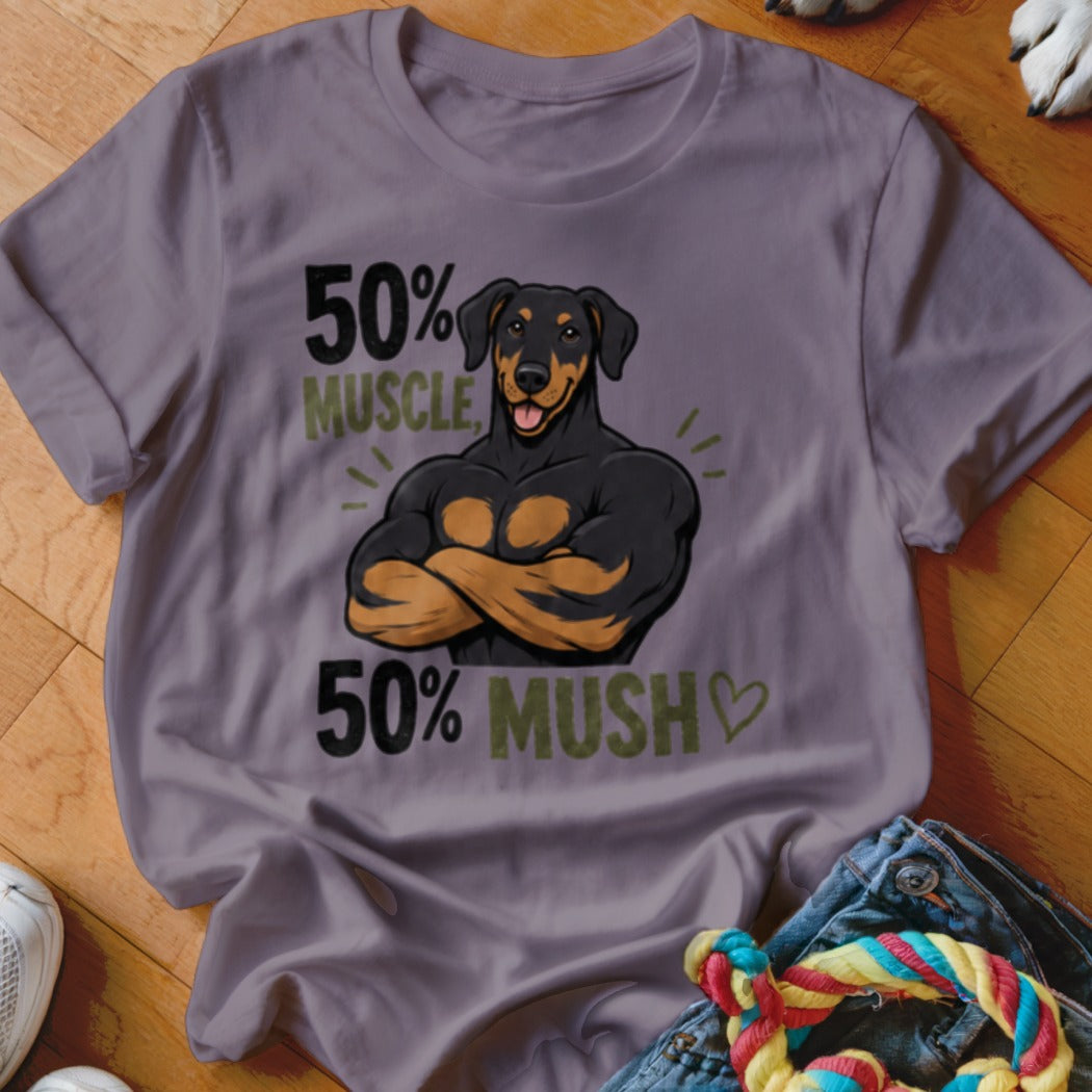 Doberman dog with muscular human arms, text "50% MUSCLE, 50% MUSH".