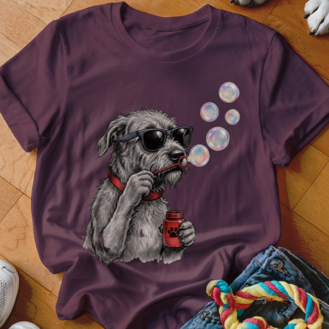 A purple t-shirt featuring a graphic of a grey dog wearing sunglasses and blowing bubbles.