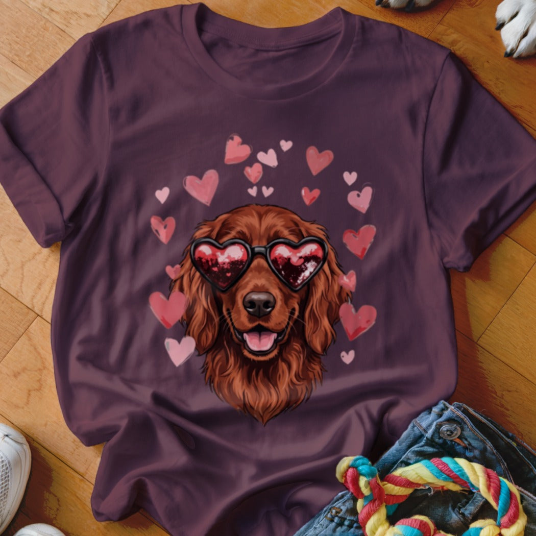 Maroon t-shirt featuring a graphic of a brown dog wearing heart-shaped sunglasses surrounded by pink hearts.