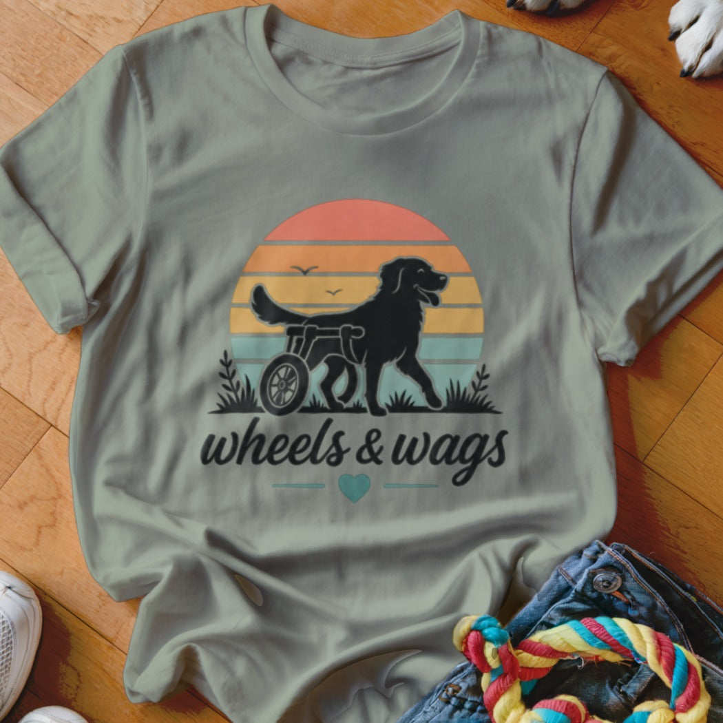 Black dog in a wheelchair with "wheels & wags" text and a heart.