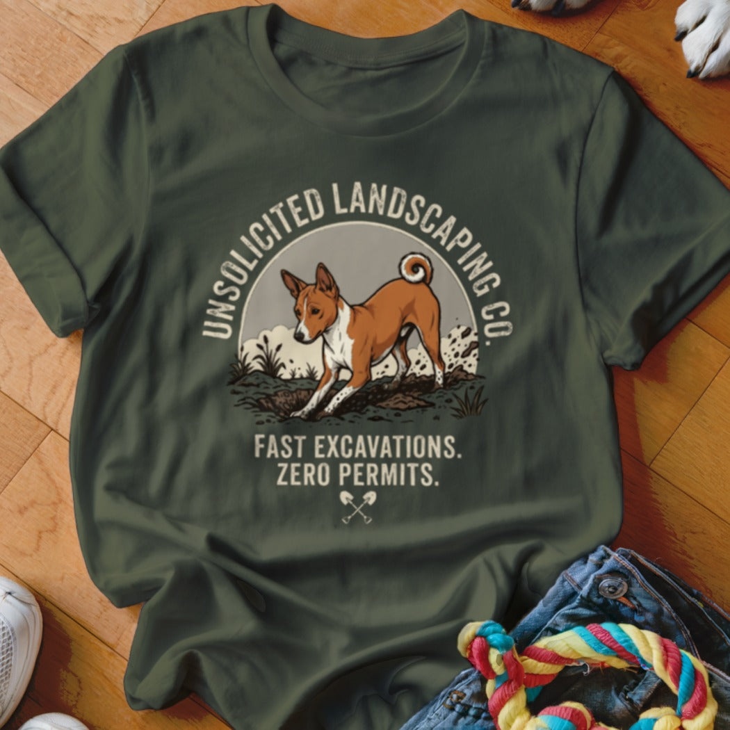 Basenji dog digging in dirt on a dark green t-shirt with text.