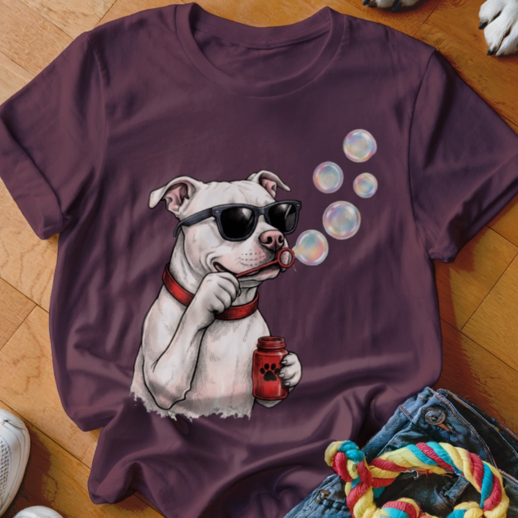 Maroon t-shirt featuring an illustration of a white pit bull wearing sunglasses and blowing soap bubbles.