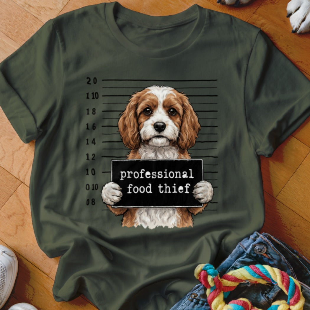 Dog wearing a mugshot sign that reads "professional food thief".