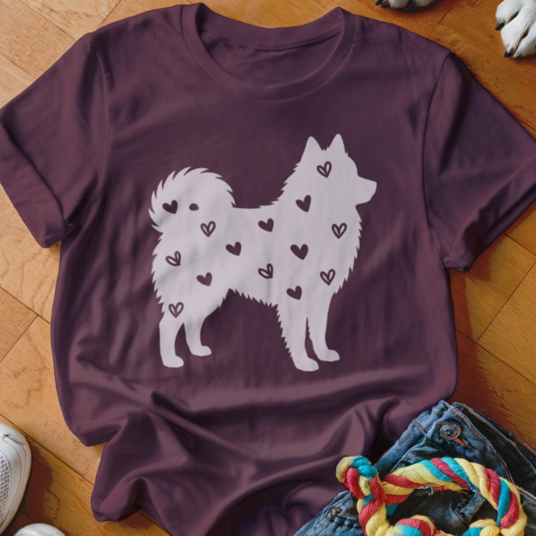Burgundy t-shirt with a white silhouette of a dog covered in small dark hearts.
