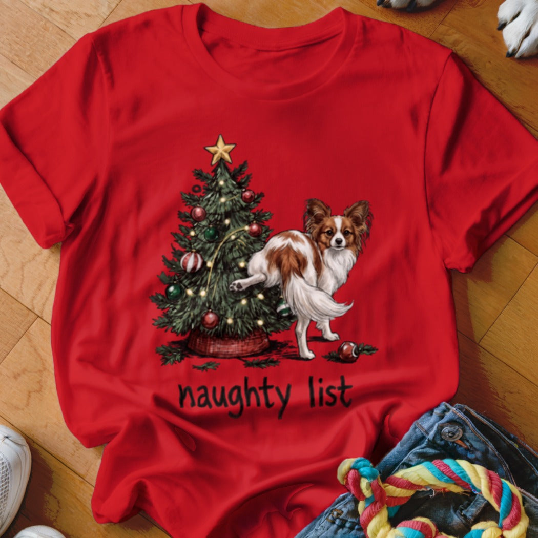 Red t-shirt with dog next to Christmas tree, reading "naughty list".