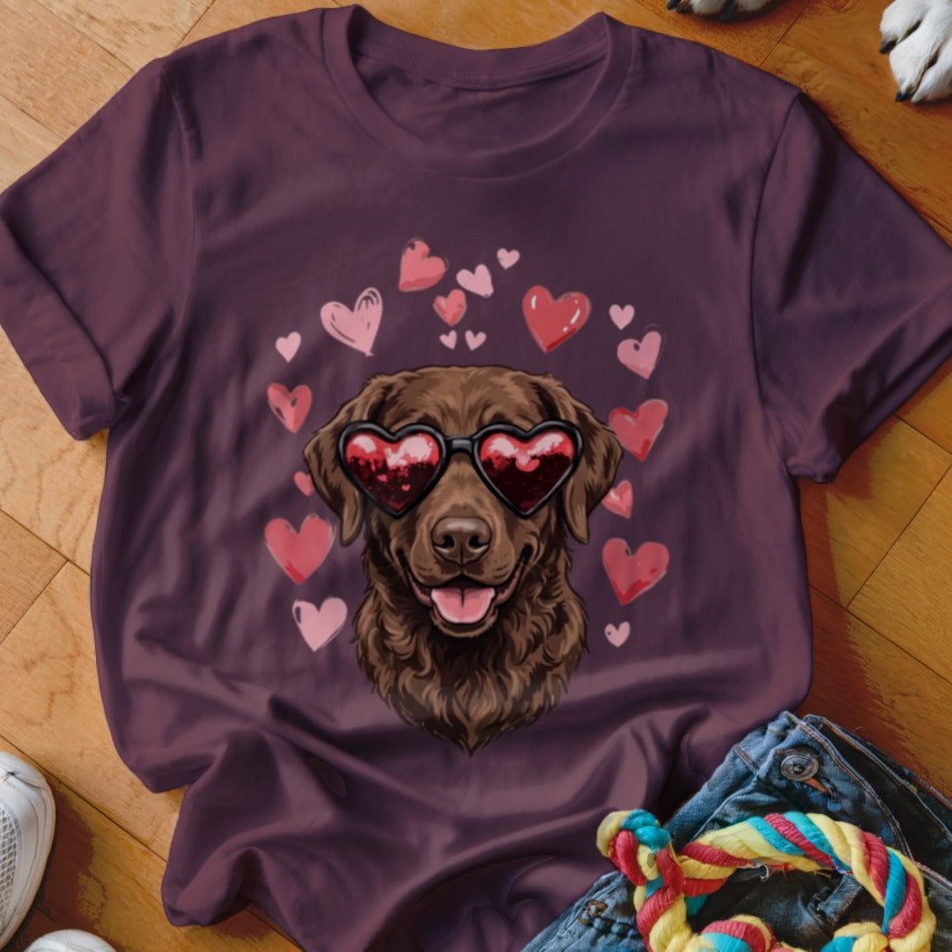 Dark purple t-shirt featuring a graphic of a brown dog wearing heart-shaped sunglasses surrounded by floating hearts.