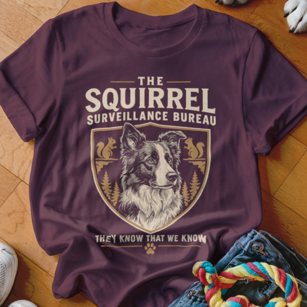 Maroon T-shirt featuring a border collie design with text reading The Squirrel Surveillance Bureau.