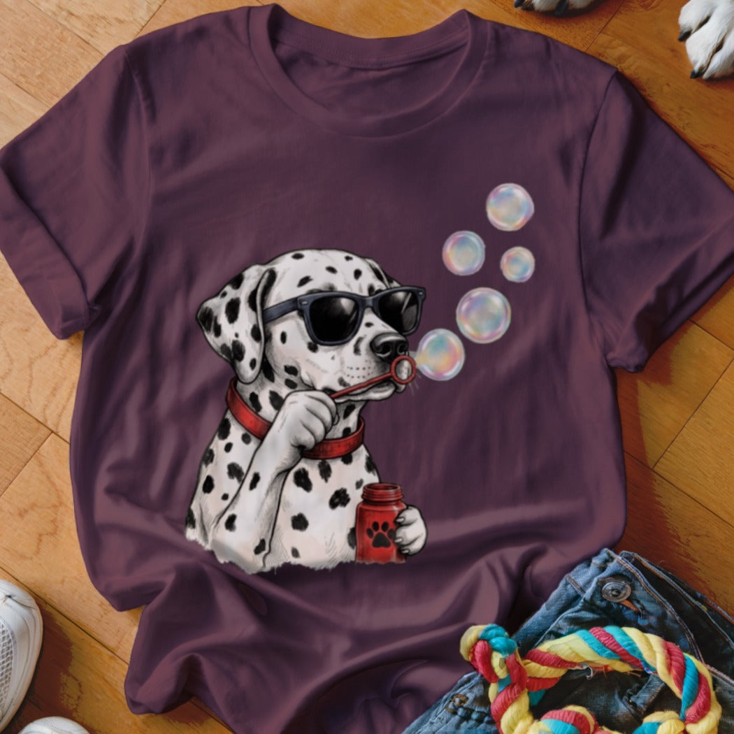Dark maroon t-shirt featuring a graphic of a Dalmatian wearing sunglasses and blowing soap bubbles.