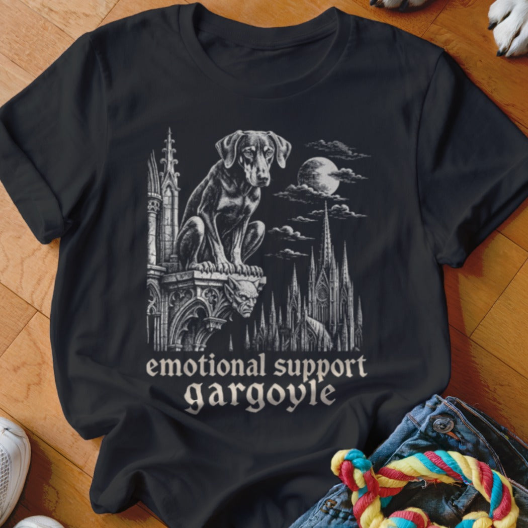 T-shirt with a dog sitting on a gargoyle and gothic architecture. Text reads "emotional support gargoyle".