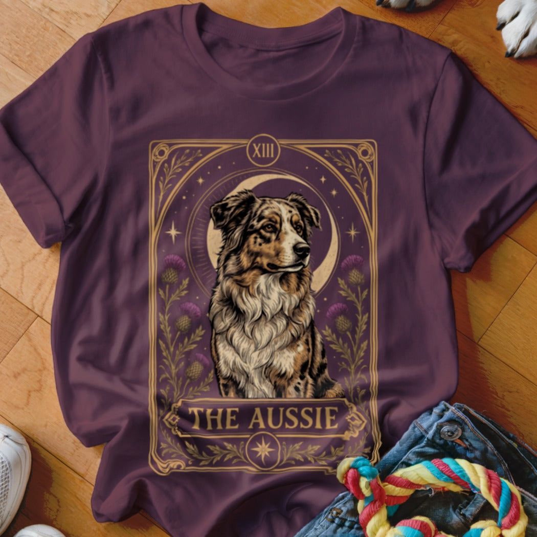 Maroon t-shirt featuring a tarot card style graphic of an Australian Shepherd with text reading The Aussie.
