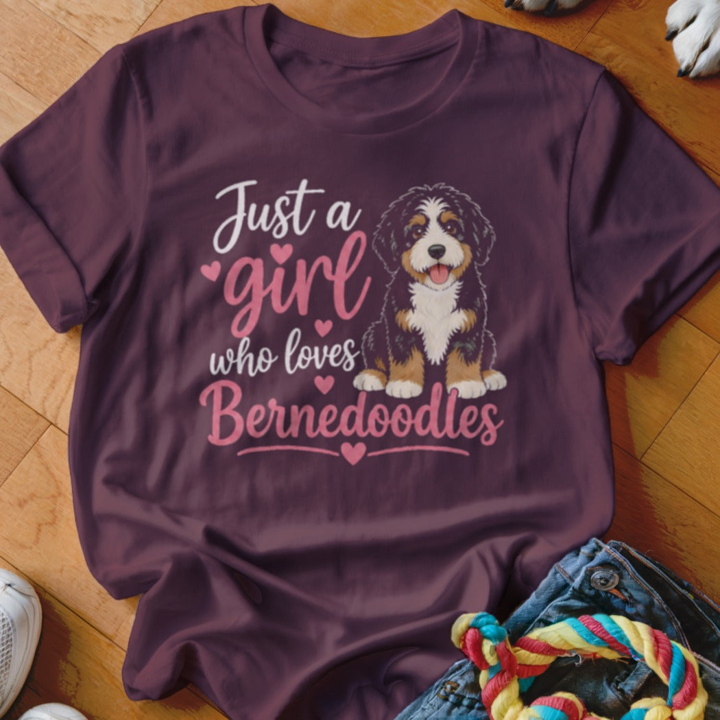 Maroon t-shirt with text "Just a girl who loves Bernedoodles" and a Bernedoodle puppy.