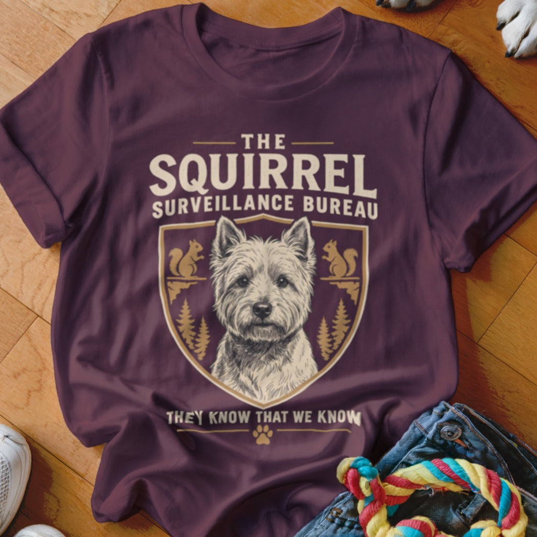 Maroon t-shirt featuring a West Highland White Terrier graphic with the text The Squirrel Surveillance Bureau.