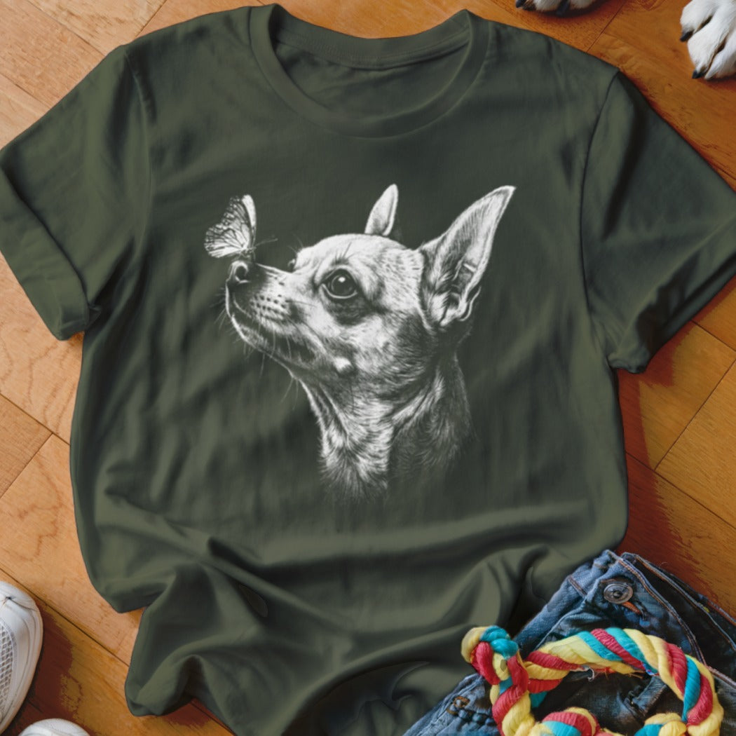 Dark green crewneck t-shirt featuring a white sketch of a chihuahua looking at a butterfly on its nose.