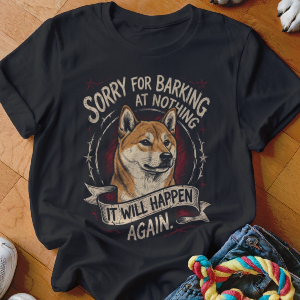 A black t-shirt printed with a Shiba Inu graphic and the text Sorry for barking at nothing, it will happen again.