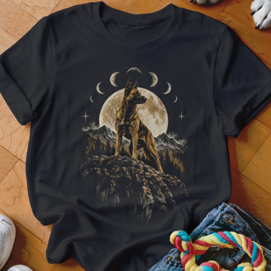 A black t-shirt features a graphic of a German Shepherd standing on a rocky outcrop before a full moon and lunar phases.