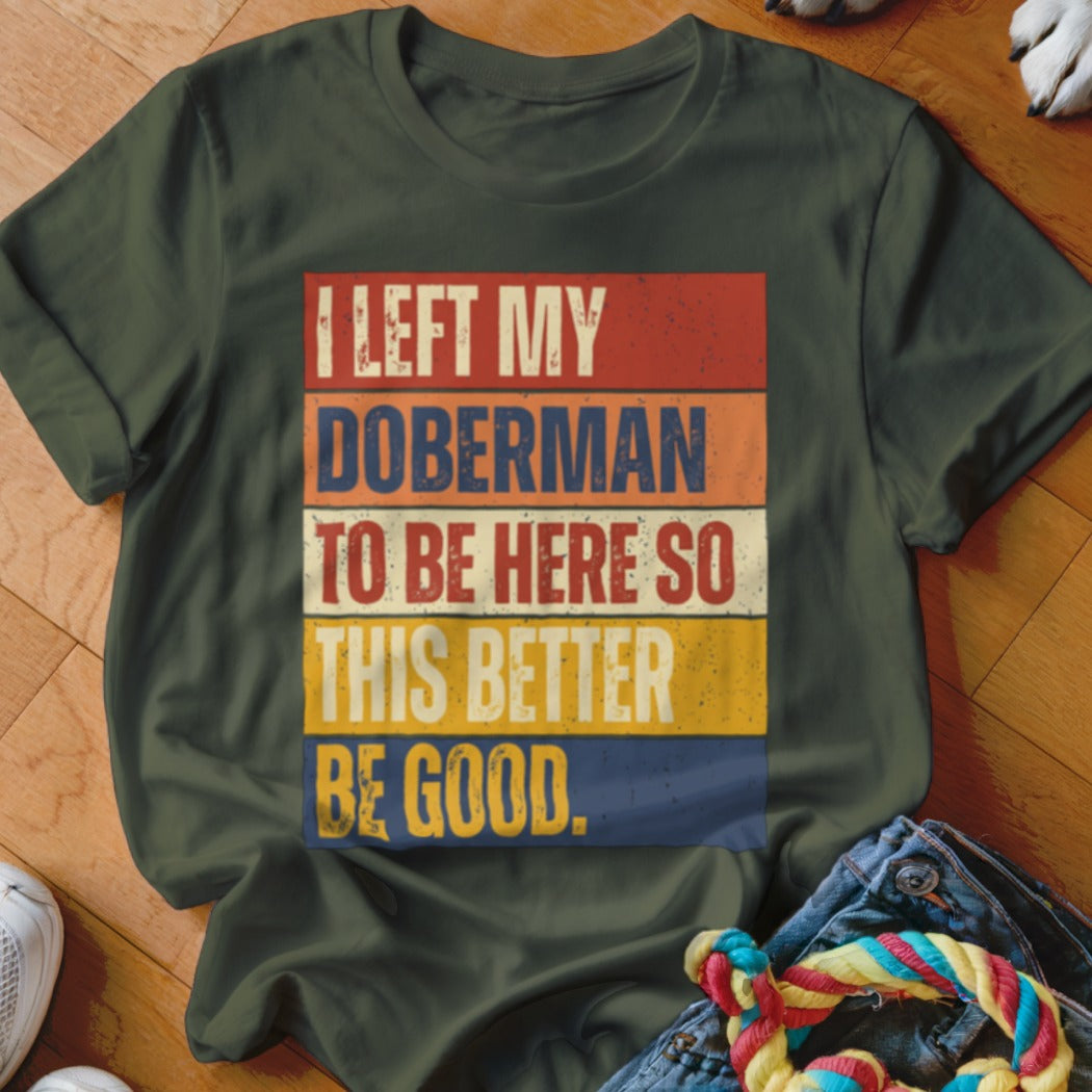Green t-shirt with text "I LEFT MY DOBERMAN TO BE HERE SO THIS BETTER BE GOOD."