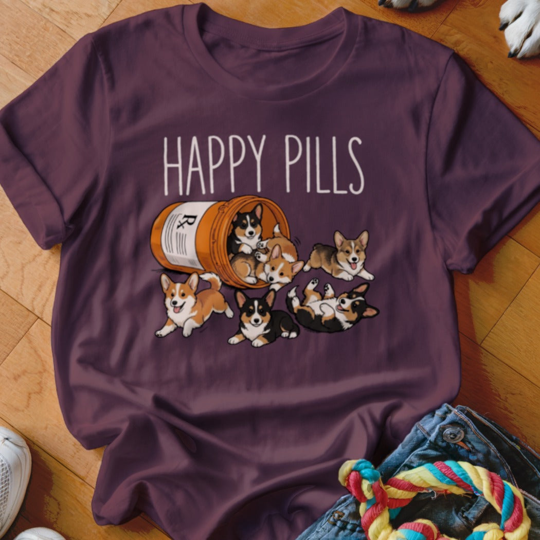 T-shirt with "HAPPY PILLS" text and a bottle of corgi puppies spilling out.