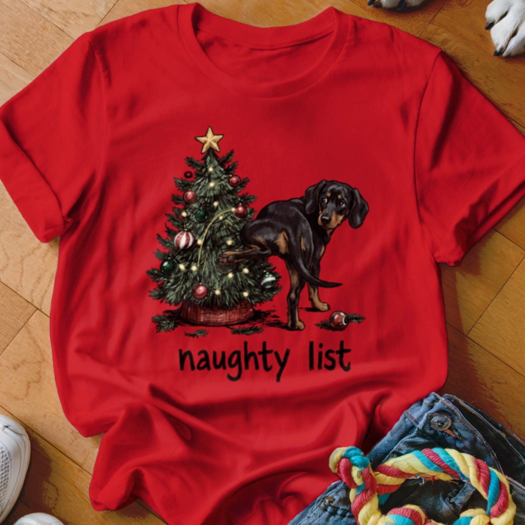 Red t-shirt with a dachshund next to a Christmas tree, with text "naughty list".