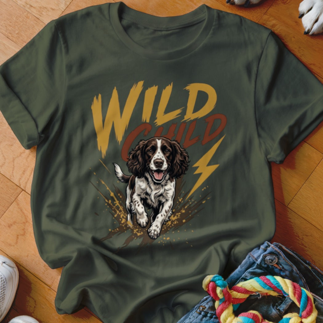 Dark green t-shirt featuring a graphic of a brown and white spaniel dog running through mud with the text "WILD CHILD".