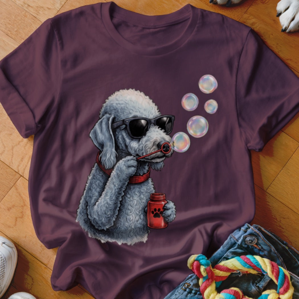 Maroon t-shirt featuring a graphic of a grey poodle in sunglasses blowing bubbles.
