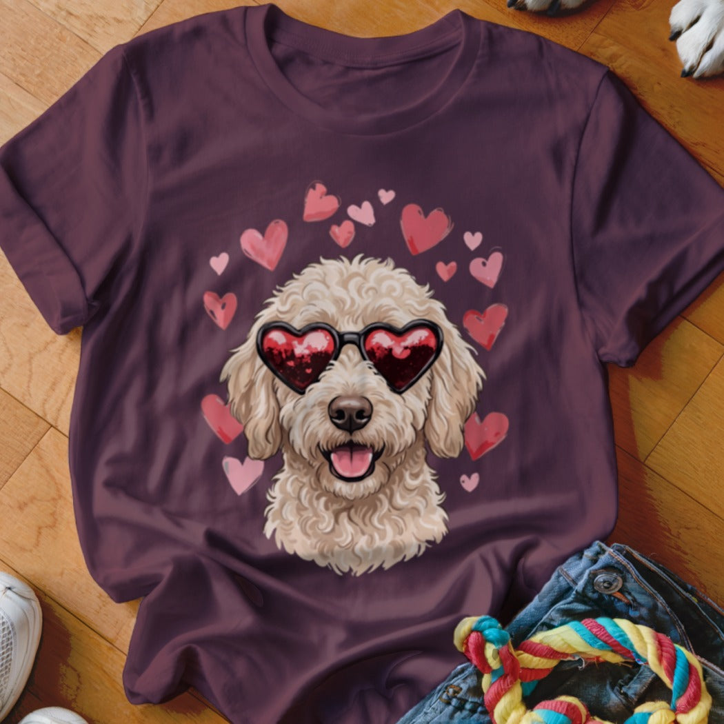 Maroon t-shirt featuring a graphic of a curly cream-colored dog wearing heart-shaped sunglasses surrounded by pink hearts.