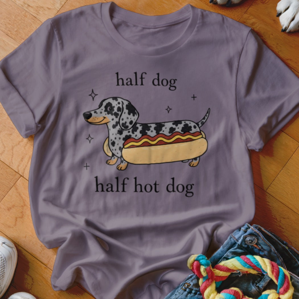 Dachshund in a hot dog bun with text "half dog half hot dog".
