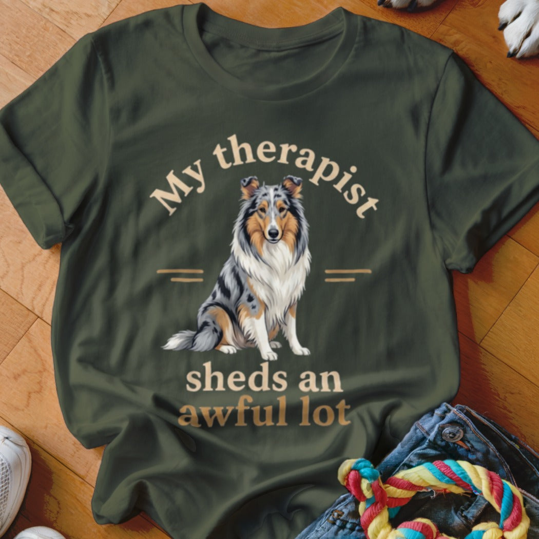 Green t-shirt with dog art and text "My therapist sheds an awful lot".