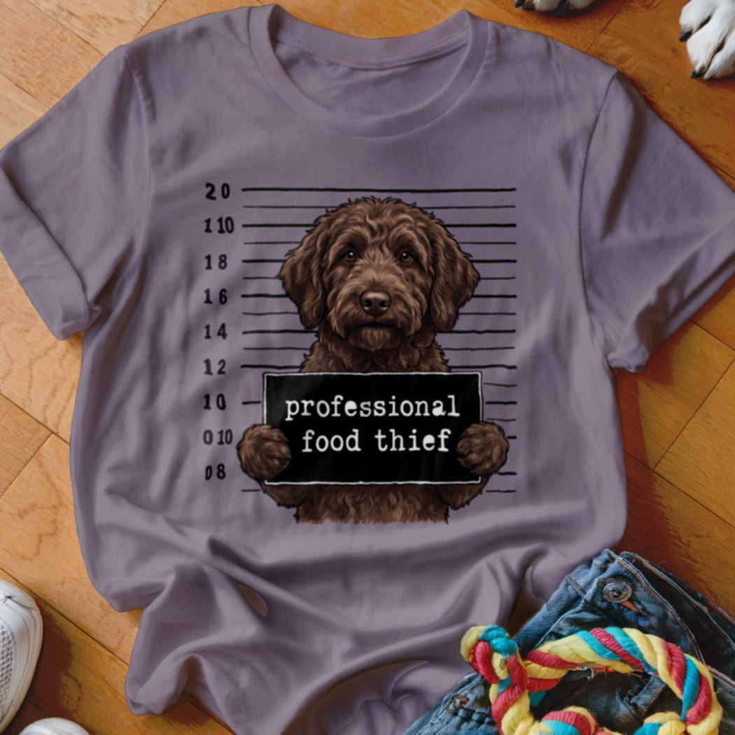 Brown doodle dog mugshot with text "professional food thief"
