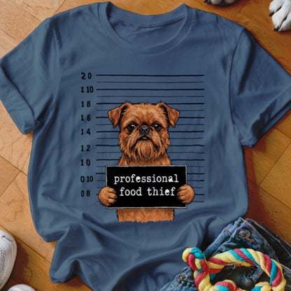 Brown dog with "professional food thief" sign in mugshot background.