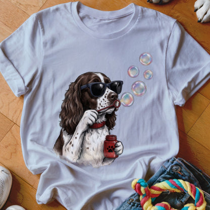 A white crewneck t-shirt featuring a graphic of a brown and white dog wearing sunglasses while blowing bubbles.