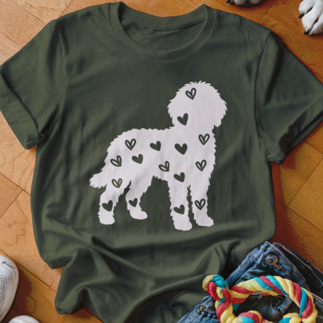 White doodle dog silhouette filled with black hearts on a dark green t-shirt.