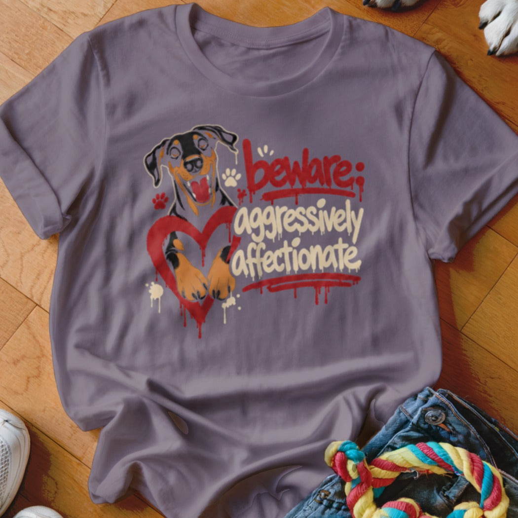 Purple t-shirt with a Doberman and heart graphic reading "beware: aggressively affectionate."