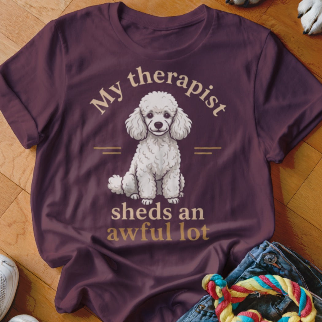 Maroon t-shirt with a white poodle graphic and the text My therapist sheds an awful lot.