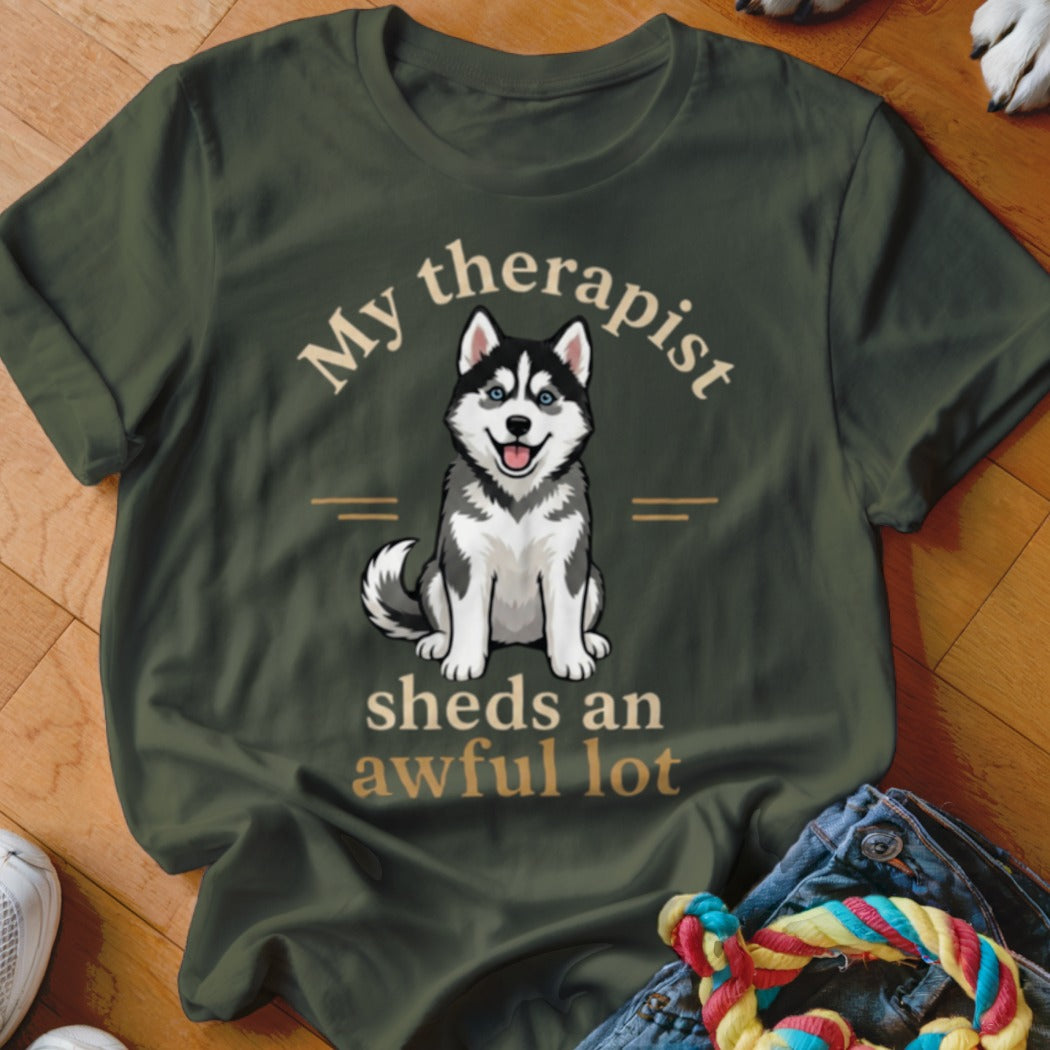 Olive green t-shirt with a graphic of a husky and text "My therapist sheds an awful lot".