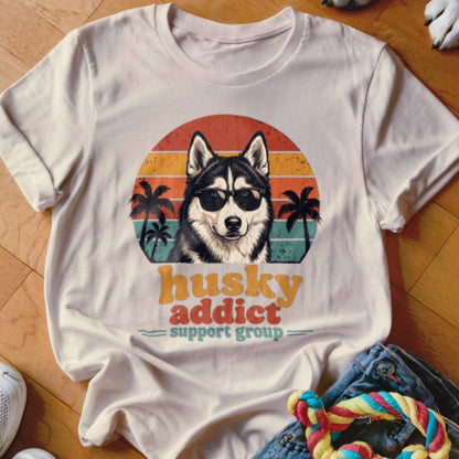 Beige crewneck t-shirt featuring a retro graphic of a husky wearing sunglasses with palm trees and sunset stripes.