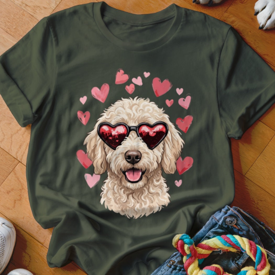 Dark green t-shirt featuring a graphic of a fluffy golden dog wearing heart-shaped sunglasses, surrounded by pink hearts.