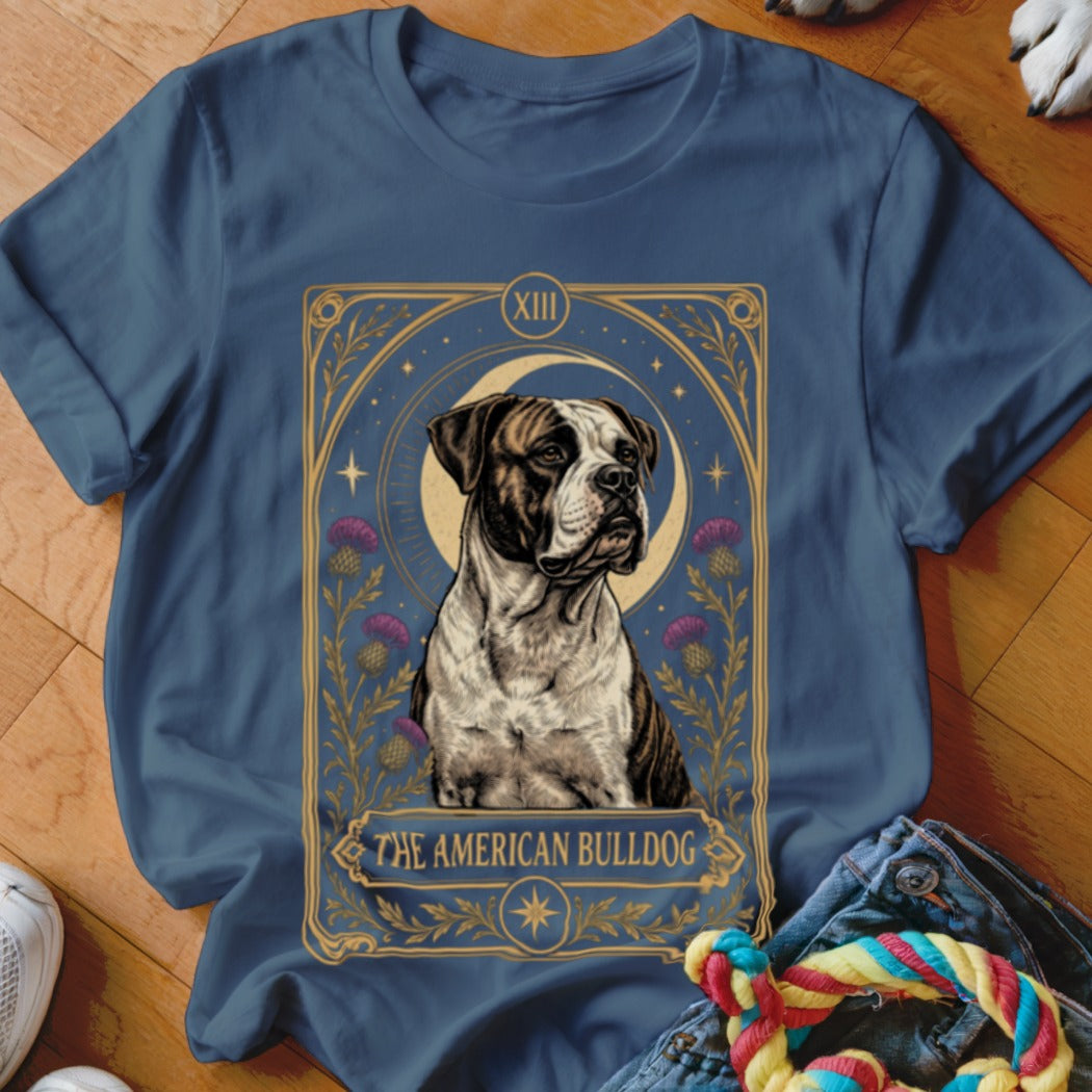 A slate-blue t-shirt featuring a tarot card graphic of an American bulldog flanked by thistles.
