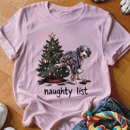 Pink t-shirt with a dog lifting its leg on a Christmas tree, text reads "naughty list."