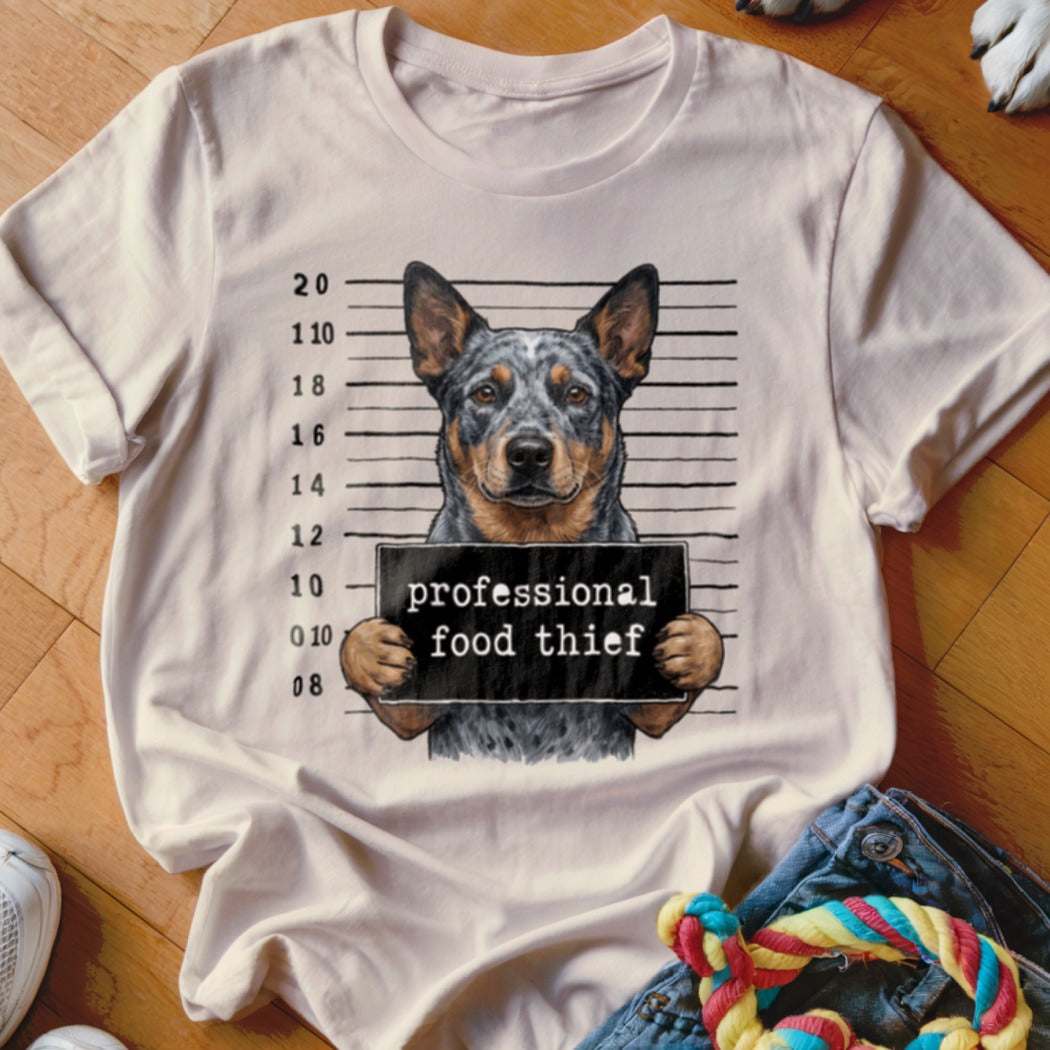 Australian Cattle Dog mugshot graphic reading "professional food thief".