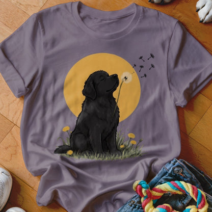 Grey crewneck t-shirt featuring a graphic of a black dog blowing dandelion seeds against a yellow sun.