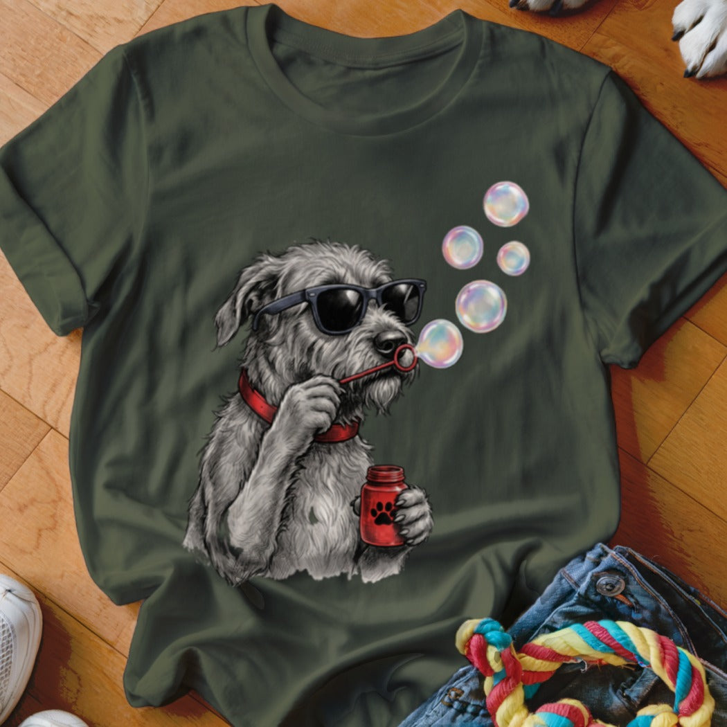 Dark green t-shirt featuring a graphic of a scruffy grey dog blowing soap bubbles.