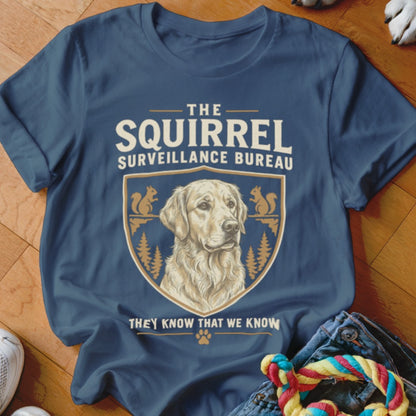 Dark blue t-shirt featuring a Golden Retriever illustration inside a crest with squirrel and pine tree motifs.