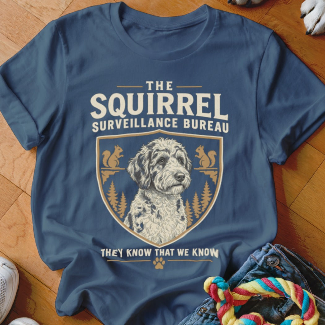 Dark blue t-shirt featuring a crest graphic of a fluffy dog and squirrels with text.