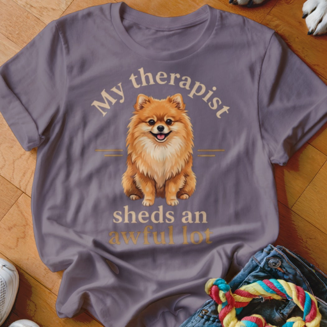 Purple t-shirt with Pomeranian dog graphic and text "My therapist sheds an awful lot".