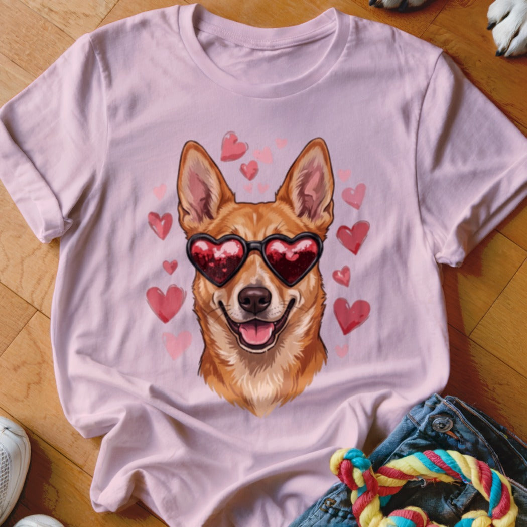 Light pink t-shirt featuring an illustration of a brown dog wearing heart-shaped sunglasses surrounded by pink hearts.