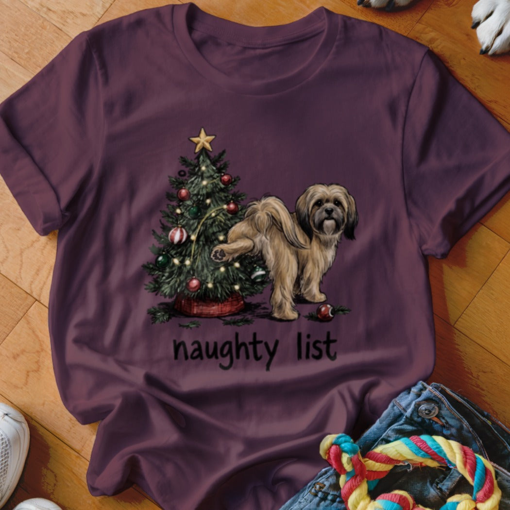 Fluffy dog near a decorated Christmas tree with text "naughty list".