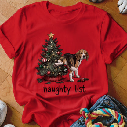 Red t-shirt with a beagle lifting its leg next to a Christmas tree, with text "naughty list".