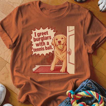 Golden retriever holding tennis ball and text "I greet burglars with a tennis ball."